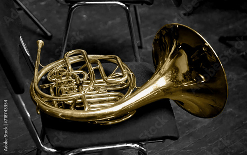  brass musical instrument horn lying on a chair photo