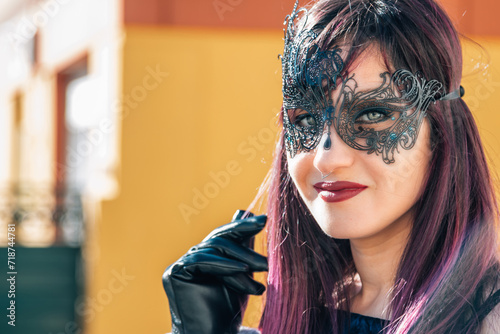 beautiful young woman with carnival mask. concept of carnival party and halloween parade