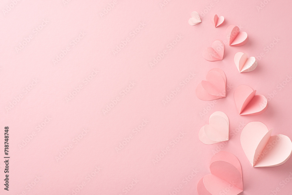 Elevate your Woman Day greetings with this captivating top view photo of hearts on a pastel pink base. A blank canvas awaits your words or promotional content to make it truly special