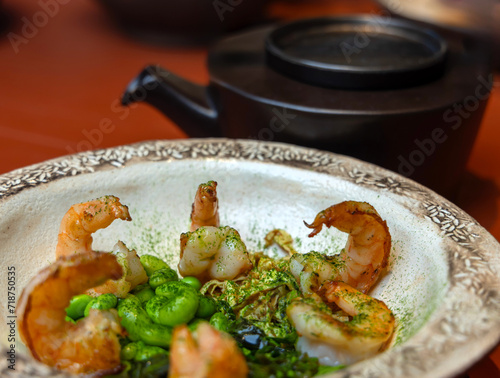 plates with dishes in restaurant. shrimps or yellow cheese soup with bacon, lamp meat or half kitchen with sauce. food in beautiful plates served on table.salad from leaves and microplants photo