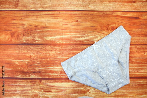 Cotton gray panties on wooden background with a copy space