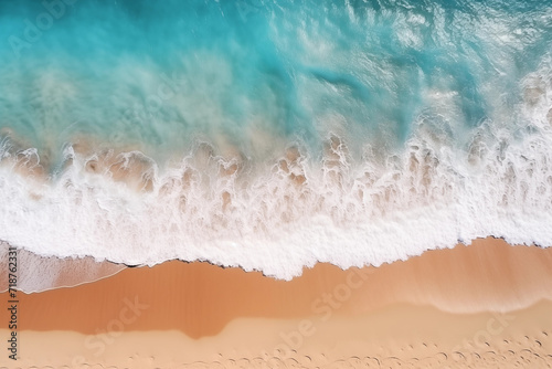 Splashing sea waves on the sand beach. Beautiful natural background at the summer time. Aerial top view of waves in tropical blue rmerald turquoise ocean