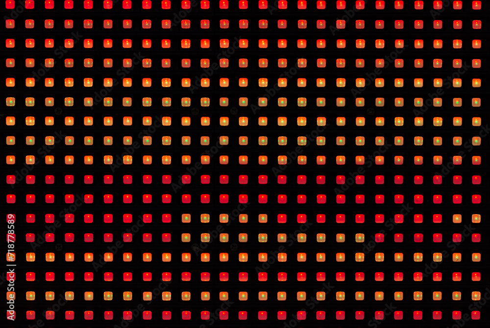 Macro image of large LED panels used for exterior advertising signs. See pixel details and gaps while displaying orange and red. Macro image of large LED panels used for exterior advertising signs. See pixel details and gaps while displaying orange and red.