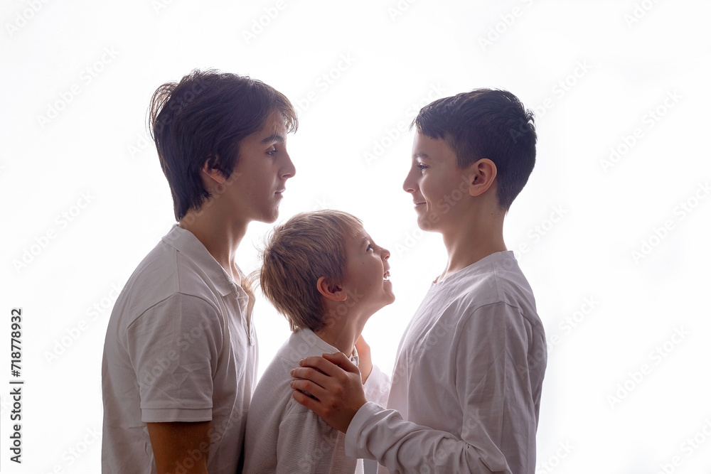 Isolated portrait on white background of siblings in studio, boys looking at each other
Isolated portrait on white background of siblings in studio, boys looking at each other