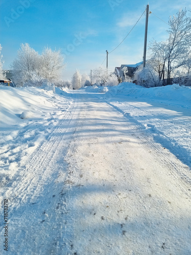 Road covered with snow in clear cold weather
