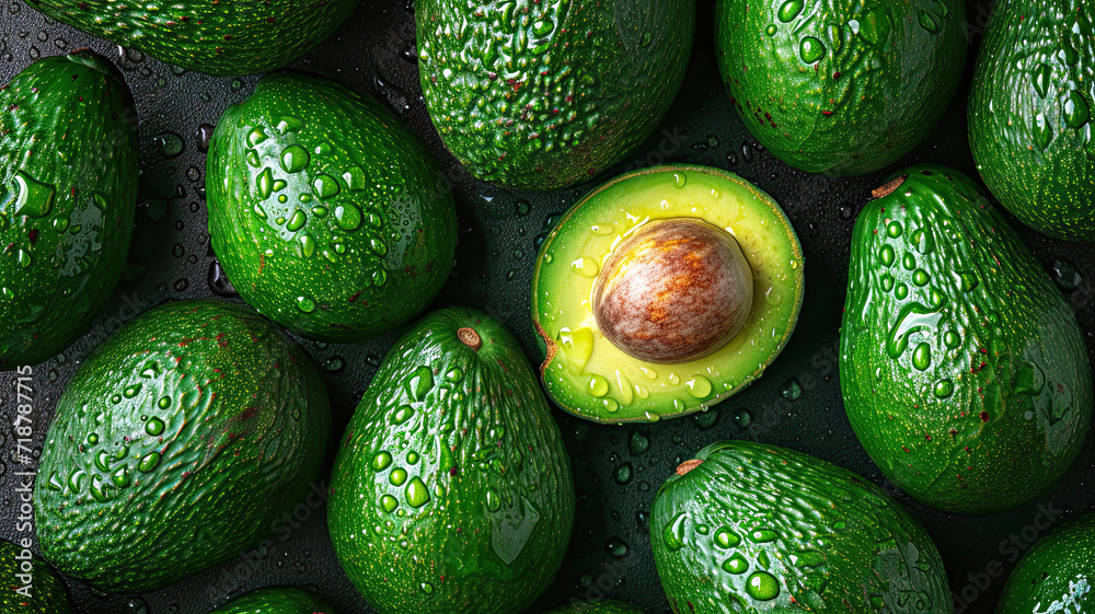 Fresh avocado with drops of water on a black background Fresh avocado with drops of water on a black background