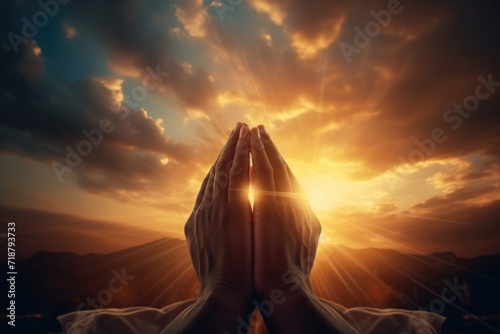 Raised hands in worship to sunset sky. Christian faith concept. photo