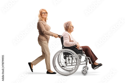 Woman pushing her mother in a wheelchair © Ljupco Smokovski