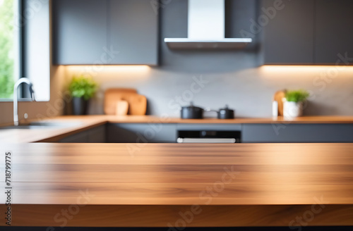 Front view of elegant interior with grey drawers kitchen cabinet. Empty wooden countertop and blur modern kitchen interior background in clean and bright, Banner, Ready for product montage