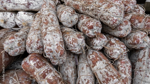 Homemade salami on sale at the Italian food market photo