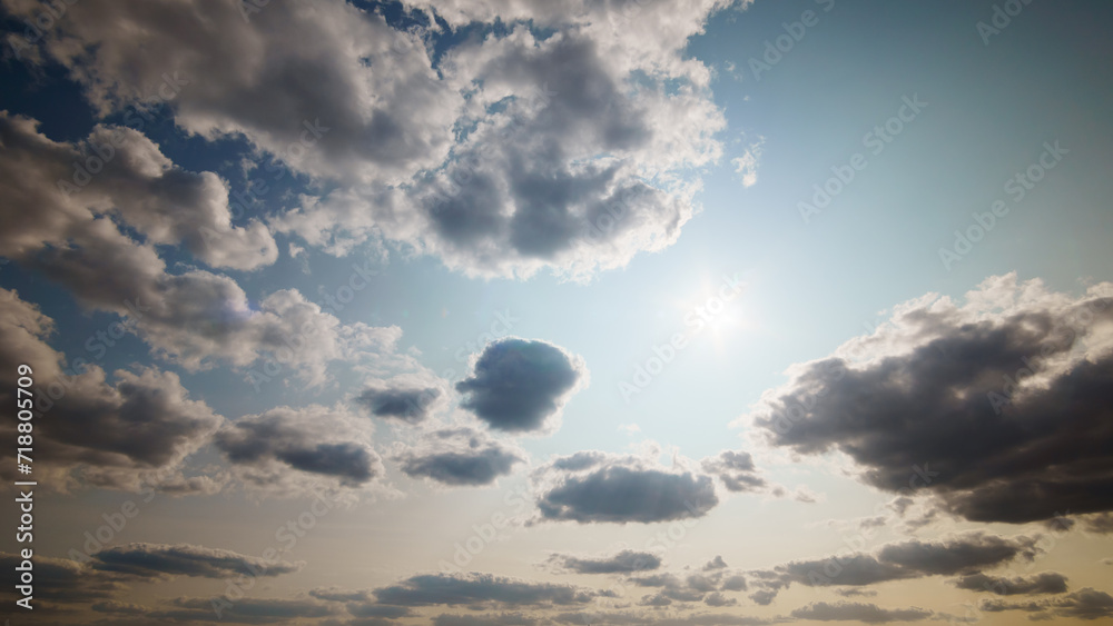 beautiful blue sky with dark dramatic cumulus clouds and sunlight for abstract background beautiful blue sky with dark dramatic cumulus clouds and sunlight for abstract background