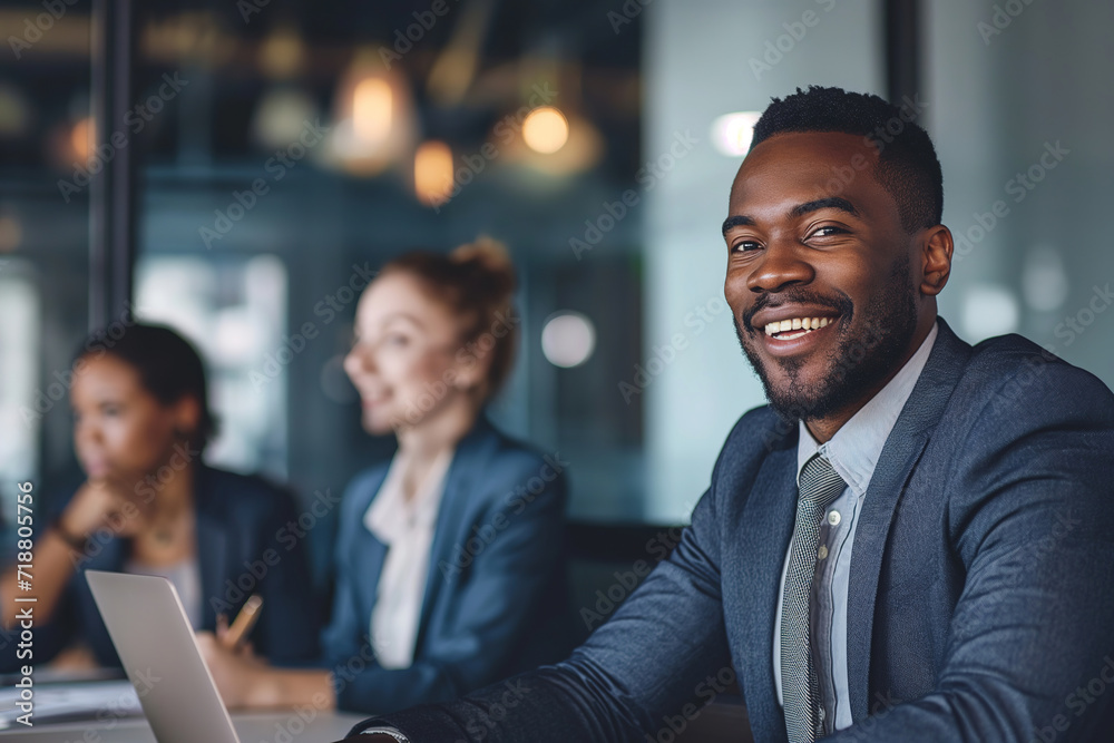 Professional business team working together in an office with his colleagues in the background Professional business team working together in an office with his colleagues in the background