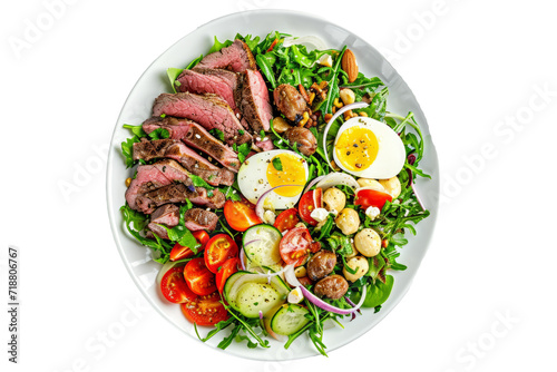 Top down view of a salad with ingredients, meat, bush tomatoes and macadamia nuts, on a white background.