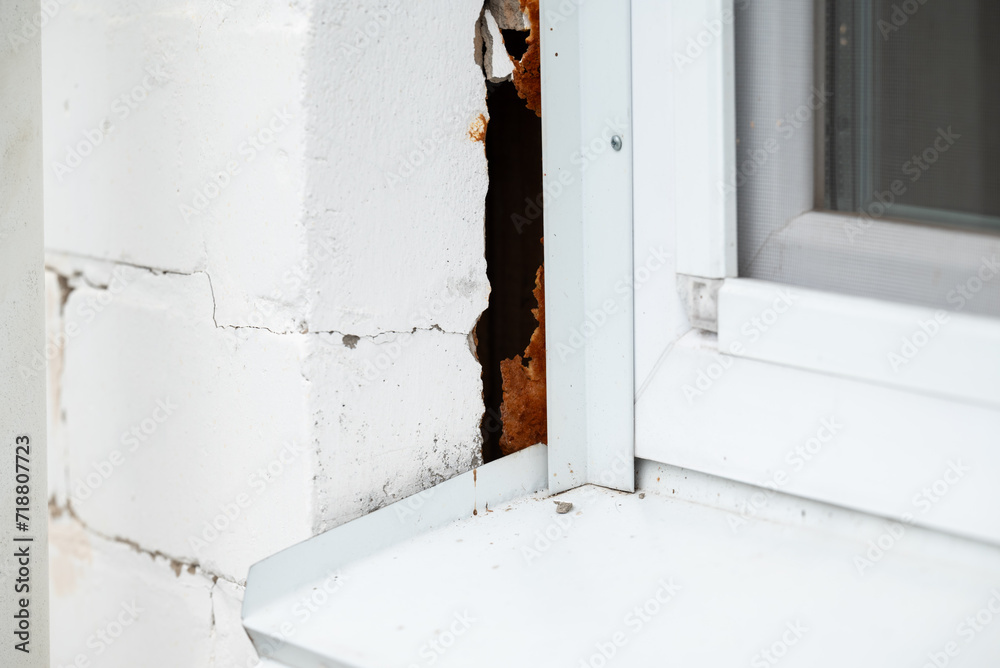 Deterioration of building, crack on the wall near window. Structural foundation errors in building, incorrect building Deterioration of building, crack on the wall near window. Structural foundation errors in building, incorrect building
