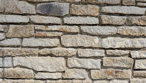 wall of stones as a texture for background  gray beige stone bricks close-up