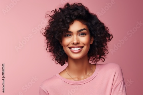 Beauty portrait of young happy smiling african american woman, over pink background.
