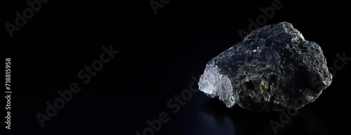 Babingtonite is a rare precious natural stone on a black background. AI generated. Header banner mockup with space.