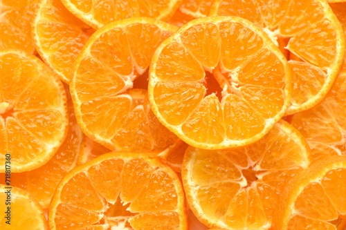 juicy and appetizing tangerines cut into circles as a food background2