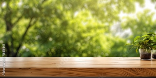 Wooden table on counter with white background, shelf and blurred green tree for food picnic and product display backdrop. Table top surface and blurred garden park in spring and summer outdoor setting