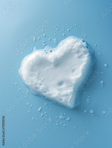 Photography of White Soap or Bubble Bath Foam in a Heart Shape Set Against a Blue Background