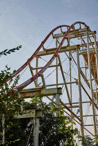 Abandoned Rusty Roller Coaster with Creeping Foliage, Ground-Up View