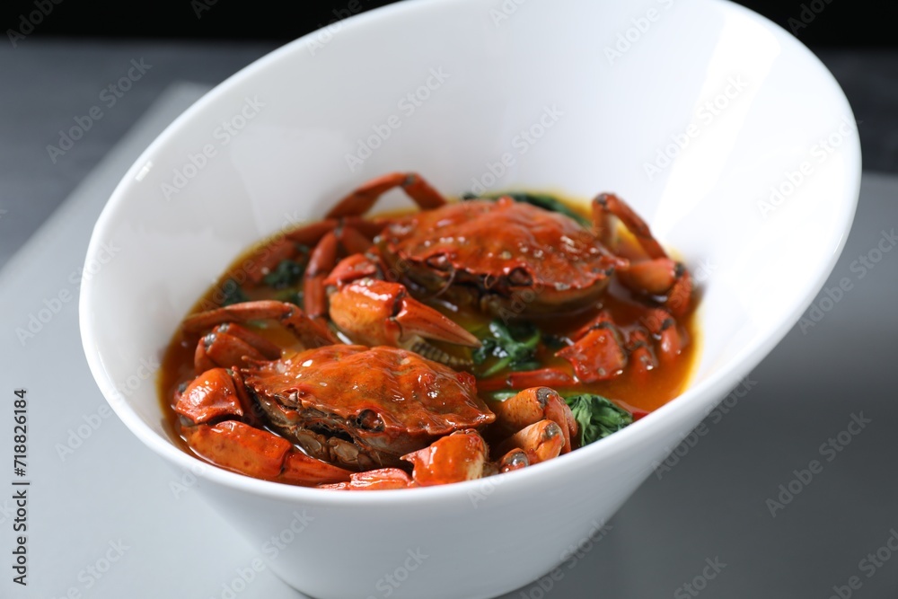 Delicious boiled crabs with sauce on table, closeup Delicious boiled crabs with sauce on table, closeup