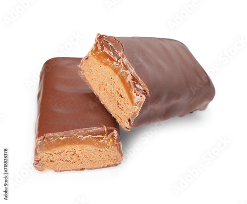 Pieces of tasty chocolate bars with nougat on white background