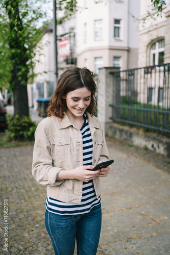 Young Woman Searching for Directions in the City with Smartphone in Hand © contrastwerkstatt