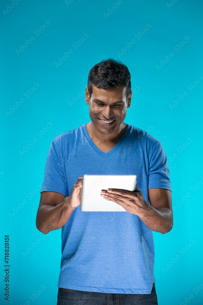 Indian man using a tablet PC Indian man using a tablet PC