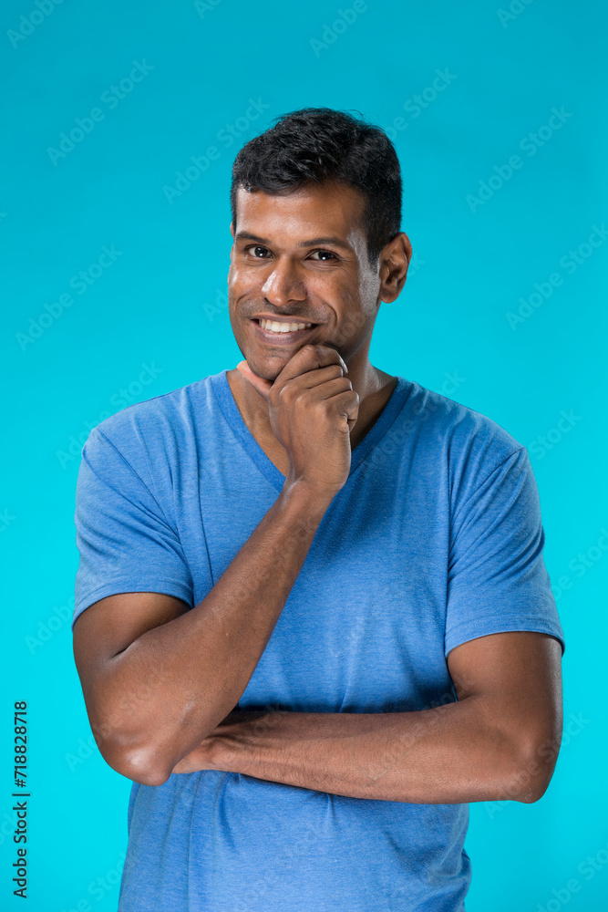 Indian man standing against blue background. Indian man standing against blue background.