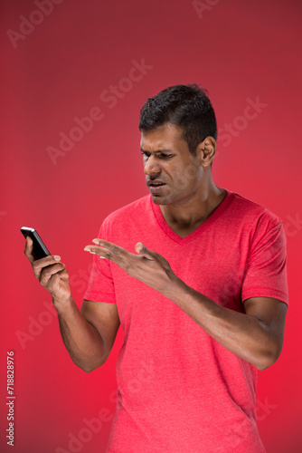 Portrait of Angry Indian man on phone.