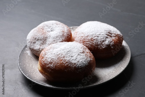 Delicious sweet buns on dark gray table, closeup