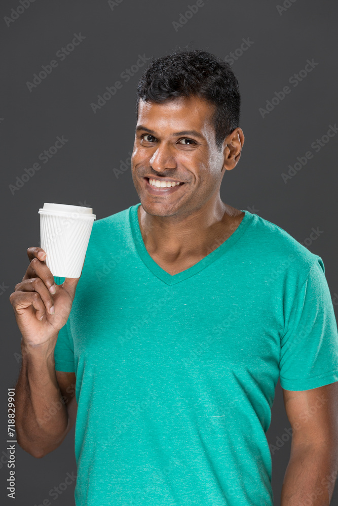 Happy Indian man with a takeaway coffee cup Happy Indian man with a takeaway coffee cup
