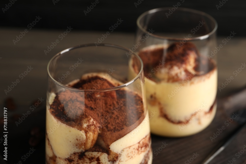Delicious tiramisu in glasses on table, closeup Delicious tiramisu in glasses on table, closeup