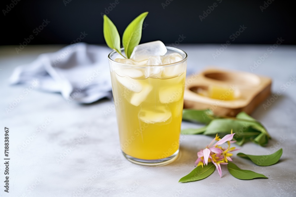 iced green tea next to loose leaves iced green tea next to loose leaves