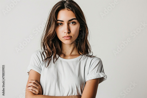 portrait of attractive serious woman with white t shirt on white isolated background