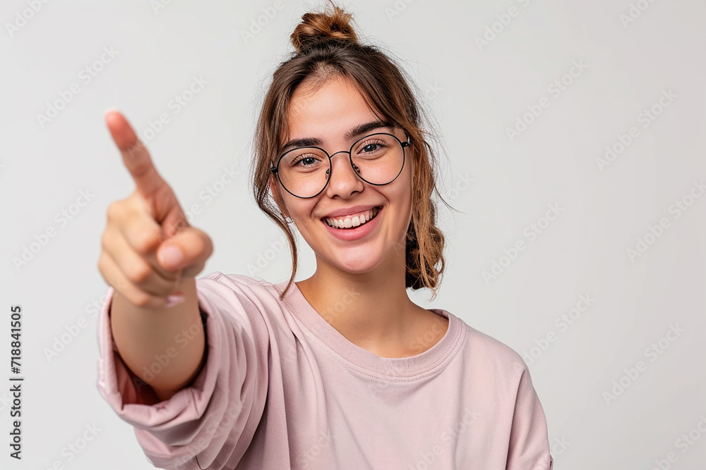 Young woman pointing front with happy expression on white isolated background Young woman pointing front with happy expression on white isolated background