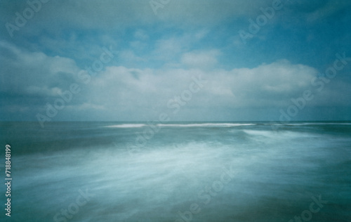 The North Sea photographed with a wooden pinhole camera, captured analogue on film. The small aperture makes for long exposure times in which sand, sea, water, sky and clouds mix with time.