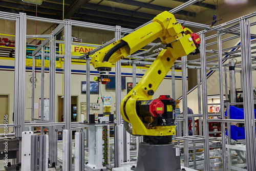 Yellow Robotic Arm in High-Tech Factory Setting photo