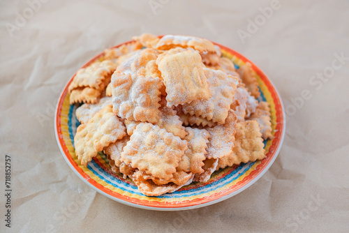 Traditional sweet crisp pastry deep-fried and sprinkled with powdered sugar. Carnival food tradition. photo