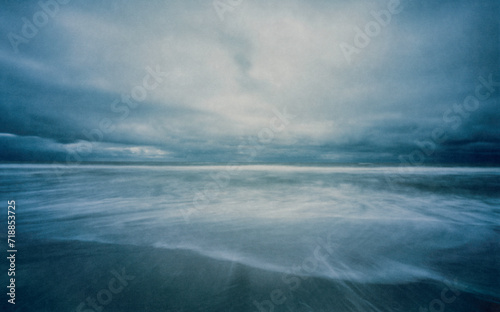 The North Sea photographed with a wooden pinhole camera, captured analogue on film. The small aperture makes for long exposure times in which sand, sea, water, sky and clouds mix with t