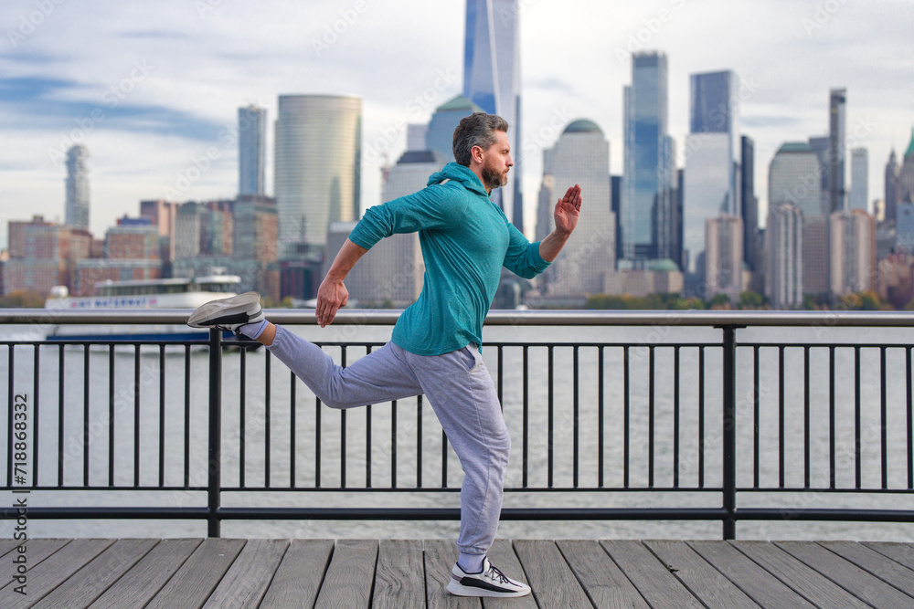 Run. Healthy Man running in New York City. Fitness sport, man runner is jogging near Manhattan. Man running on American street. Man running in New York in sport clothes. Sport wear for mature runners.