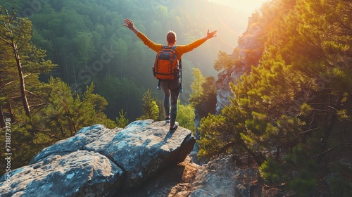 Happy man with arms up jumping on the top of the mountain - Successful hiker celebrating success on the cliff