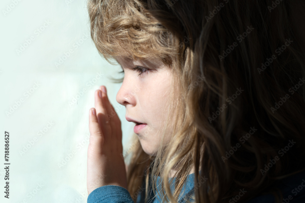 Child dream near window. Kids dreaming face close up. Lifestyle portrait of cute kid. Adorable little blond kid boy sitting near window. Child dream near window. Kids dreaming face close up. Lifestyle portrait of cute kid. Adorable little blond kid boy sitting near window.