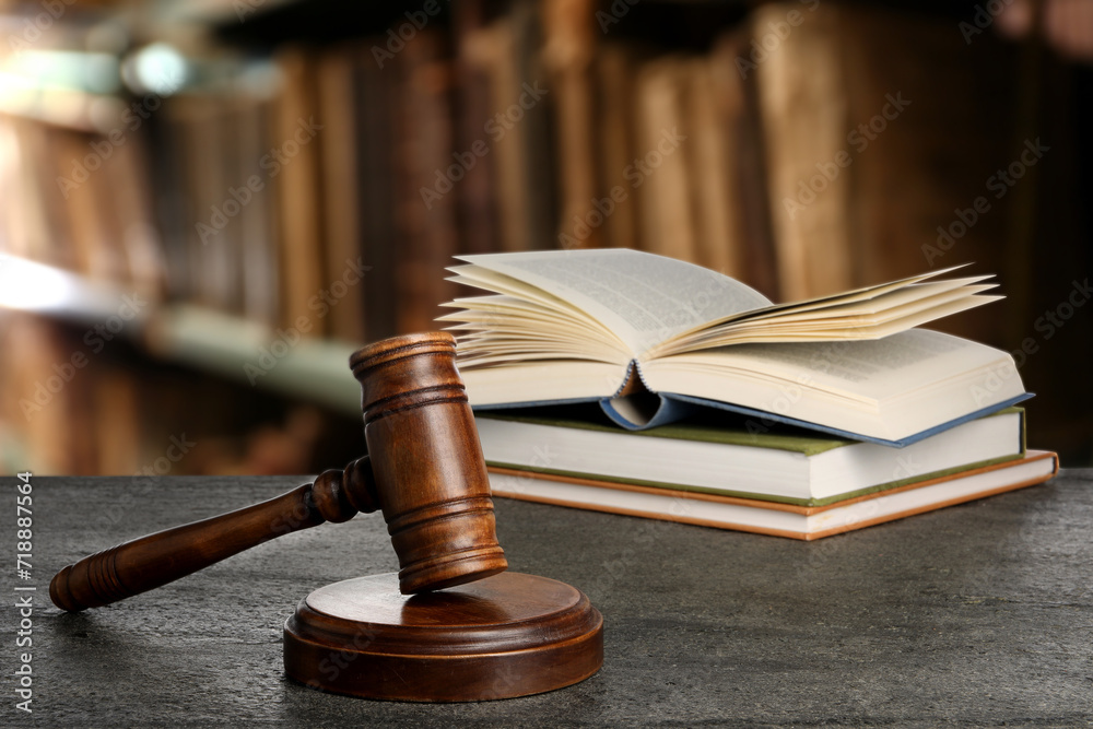 Law. Judge's gavel and books on grey table indoors Law. Judge's gavel and books on grey table indoors