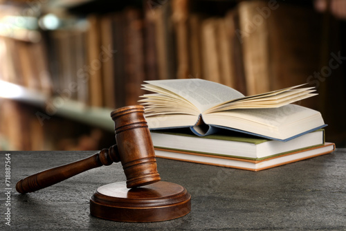 Law. Judge's gavel and books on grey table indoors