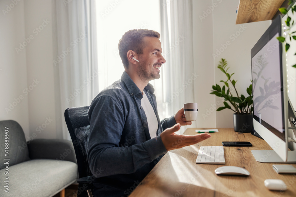 A freelancer is having conference call at home office. A freelancer is having conference call at home office.