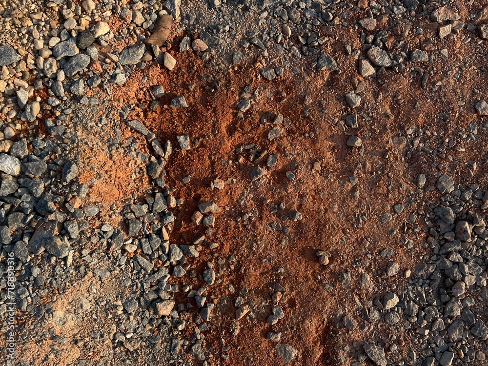 texture background with stones on the red soil texture background with stones on the red soil