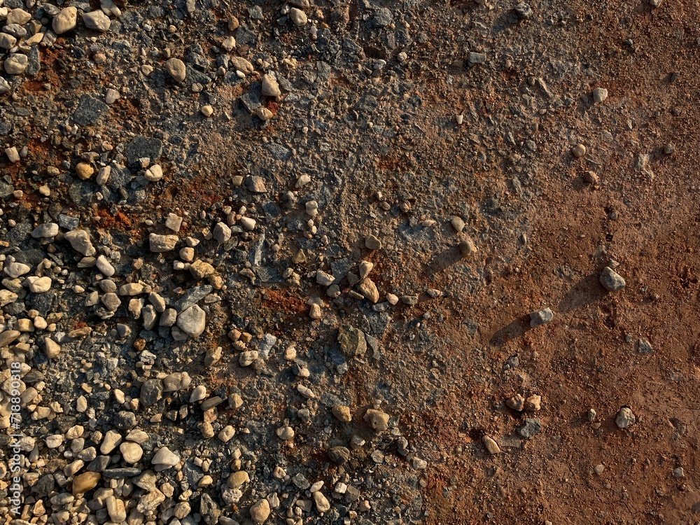 texture background with stones on the red soil texture background with stones on the red soil