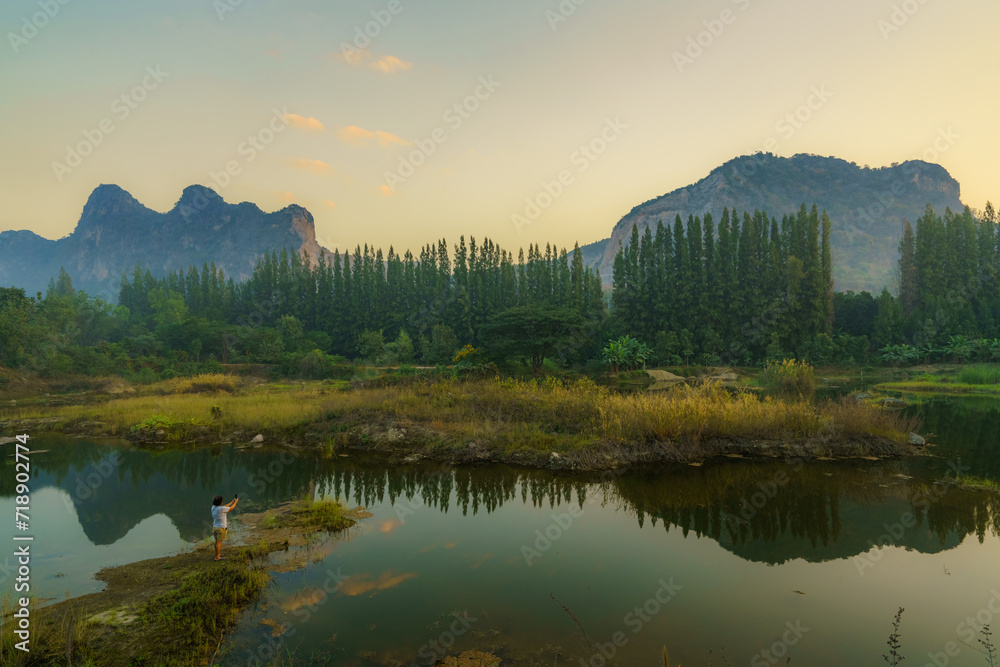  A tranquil landscape capturing the beauty of mountains, a reflective lake, and the serene embrace of nature in the morning light